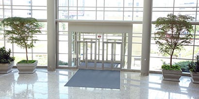 commercial building entrance cleaned with 3M commercial cleaning products with 3M floor matting for anti-slip prevention and floor safety