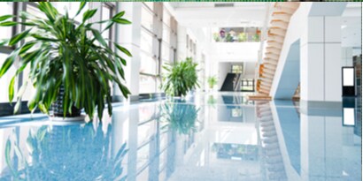 a commercial building interior with natural light shining in on immaculately clean floors and walls.
