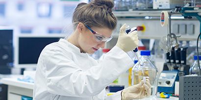 woman performing science lab test
