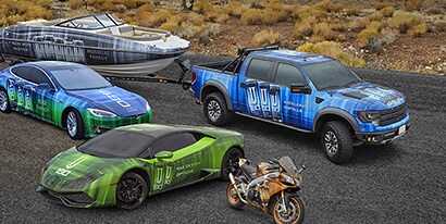 Two cars, a motorcycle and a truck with a speedboat wrapped in blue, green, gray and orange 3M™ Wrap Film Series 2080.
