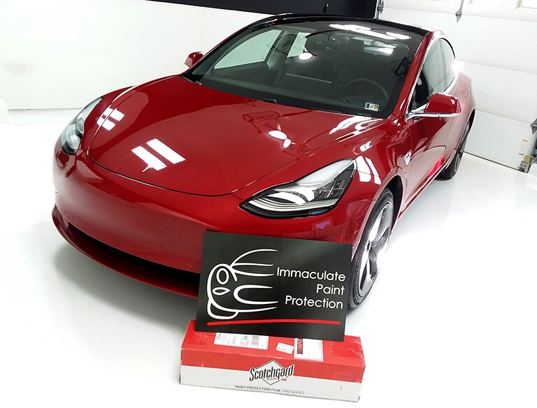 red car covered with 3M paint protection film
