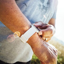 a person outside checking their smart watch.