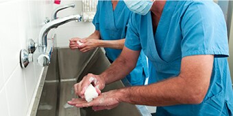 A health care provider washing hands
