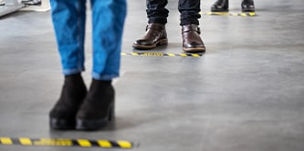 有人在地板安全標示處等待
