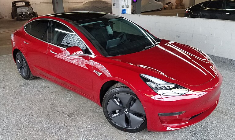 red car covered with 3M paint protection film
