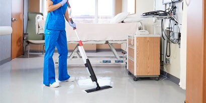 woman cleaning a patient room floor with the Scotch-Brite Professional Mopping and Floor Finish Applicator System