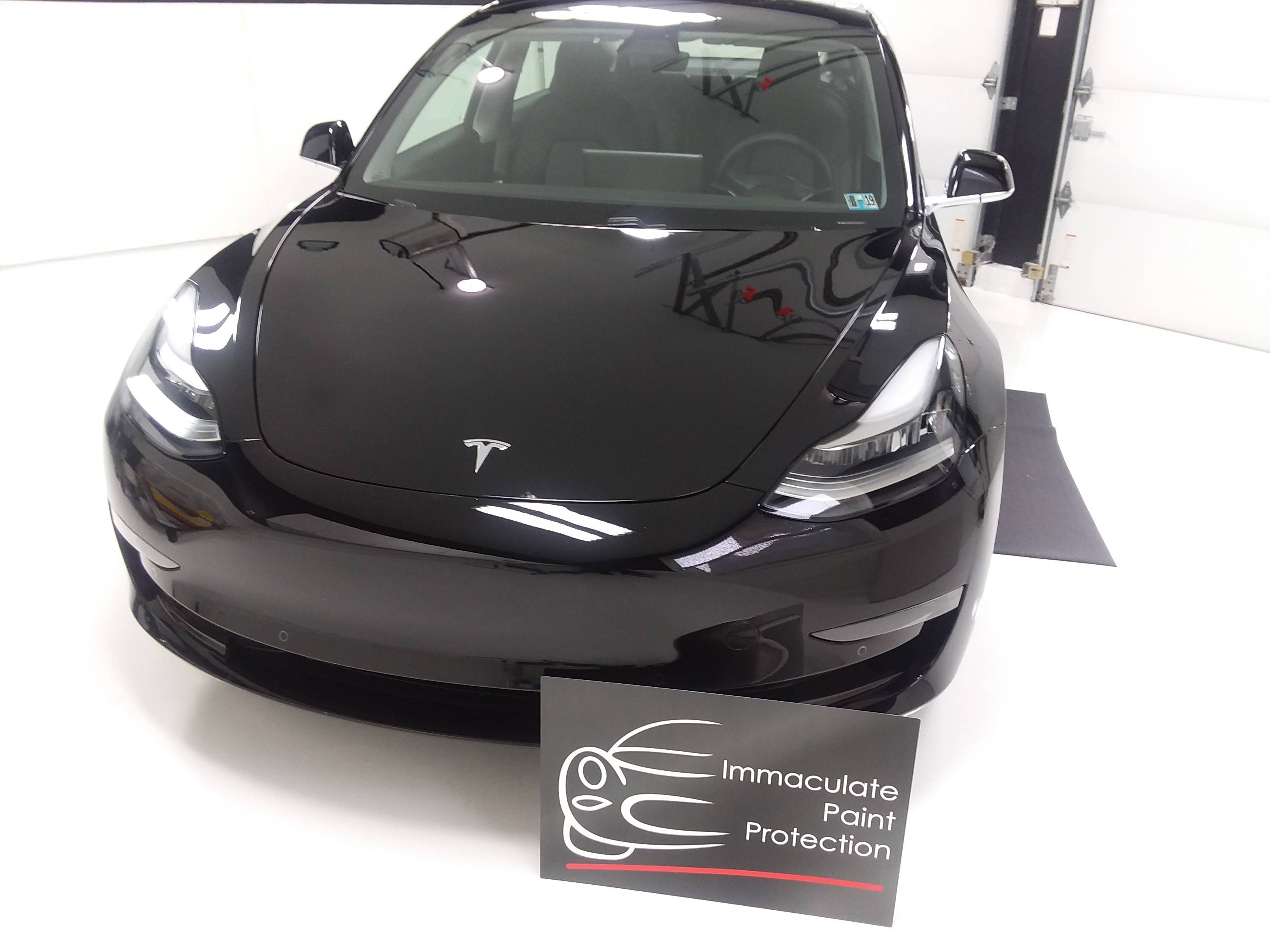 black car covered with 3M paint protection film
