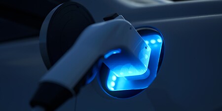 Image of electric car battery charging in the dark
