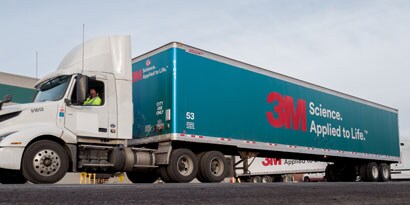 A semi-truck’s trailer is wrapped in a blue fleet wrap with the 3M logo.
