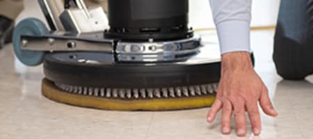Employee inspecting a recently polished coated concrete floor.
