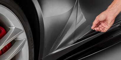installer adding paint protection film to a car
