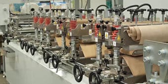 Video still of production equipment on a plastic pouch manufacturing line

