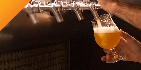 Glass of beer being filled from the tap.
