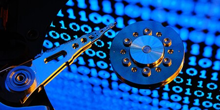 Photo of stylized Hard Disk Drive in manufacturing process.
