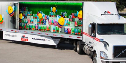 long fleet truck with a colorful graphic wrap.