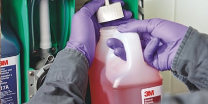Someone screwing on the lid of a cleaning solution

