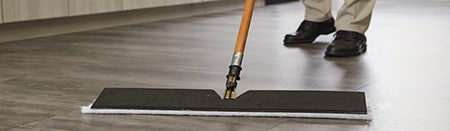 Close-up of a mop on laminate hardwood floors.
