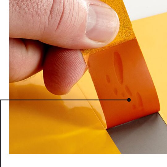Image of masking tape being removed from a painted metal sheet without residue or slivering