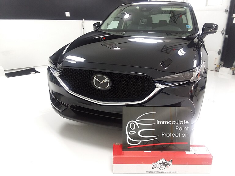 black car covered with 3M paint protection film
