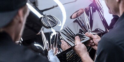 restyler applying a car wrap
