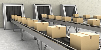 Image of three conveyor belts filled with sealed cartons
