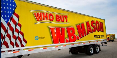 The flag image and lettering on a semi-truck’s fleet wrap are vibrant and bright.
