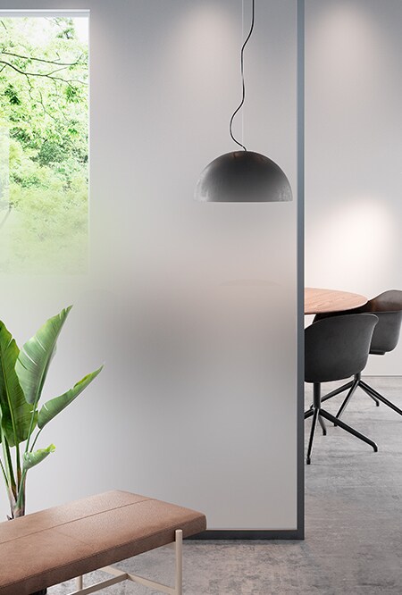 Image of an office showing a conference table obscured by a glass panel covered in FASARA Mist-PR
