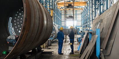 Two people inside of manufacturing facility
